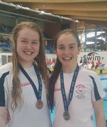 Maeve Cleland (left) and Julia Knox (right) show off their medals.