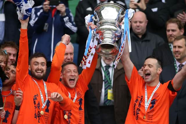 Glenavon skipper Kris Lindsay lifts the trophy along with captain for the day Ciaran Martyn. Picture by Brian Little/Presseye