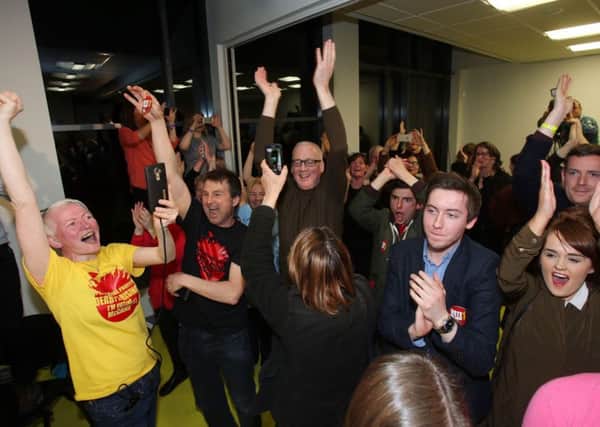 Eamonn McCann's supporters cheer as his election to Foyle is announced as counting of votes continues at the Foyle Arena in Derry on Saturday. (Niall Carson/PA Wire )