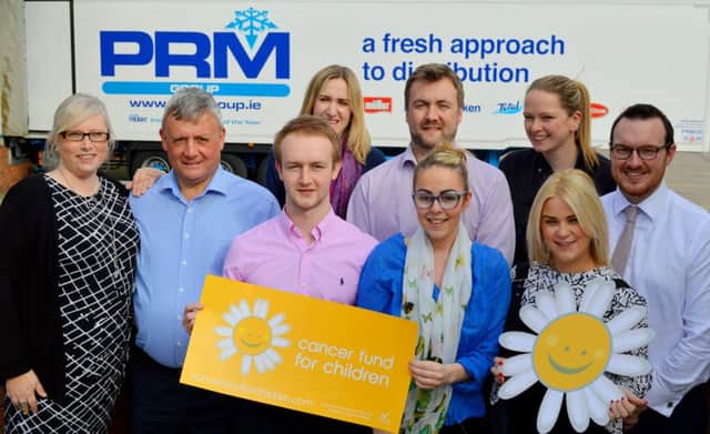 Caption:  Ana Wilkinson Cancer Fund for Children Corporate Fundraiser and Philip Morrow Managing Director of PRM Group LTD launch their new charity partnership with members of the companyÃ¢Â¬"s Charity Committee.