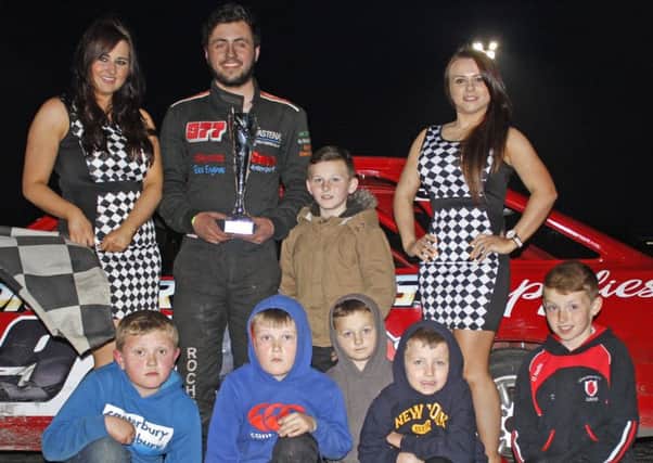 Portadown-based Jordan Rochford was promoted into top spot at Tullyroan Oval across the Lightning Rod final. Making the presentation are young race fans and representatives of the trophy sponsor, George Fegan Tyres of Belfast. Pic by Brian Lammey.