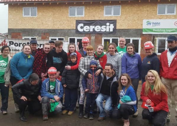 Friends School Habitat Team with the families they assisted on a recent project trip to Romania.