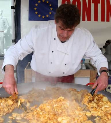 Geort from the German Barbeque stall prepares a traditional German dish which includes potatoes, onions and bacon at the Continental Market at Junction One. AT15-336JC