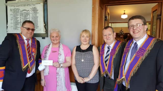Representatives of Dromore's Via Wings receive a Â£450 cheque from Bro Colin Cunningham,  Royal Black Institution Lower Iveagh Deputy District Master (left). Included are  WDM Bro David Hunter, District Treasurer and Bro William Martin.