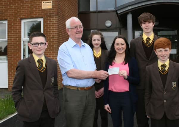 Mary Campbell, Head of Languages at Cross and Passion College, Ballycastle, accepts a bursary cheque presented by Seamus Blaney on behalf Moyle Twinning Association at the school on Thursday. Also pictured are four students Sean Brogan, Uainin Sands-Robinson, Joe McToal and Conor Henry. INBM21-16S