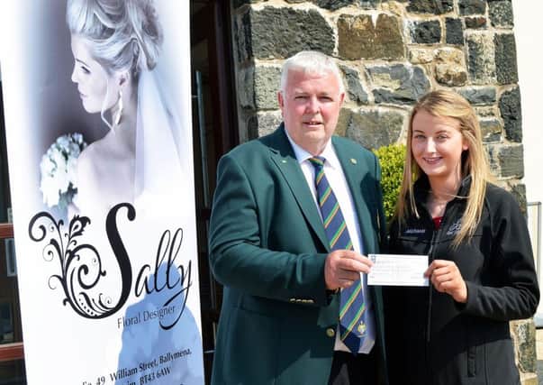 Sally's Florist studio representative Michaela Scullion presents a sponsorship cheque to Galgorm Castle Golf Club Captain Ian Henry. INBT 21-801H