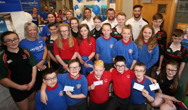 Ian Humphreys, Andrew Warwick and Sam Windsor from Ulster Rugby who attended the Make A Wish charity day and Health and Wellbeing event at Bank of Ireland Broadway are seen here with pupils from Ballymena Primary School and Cambridge House Grammar School. Included are BOI staff branch manager Jan Young and staff member Christine Reid.
INBT 20-104JC