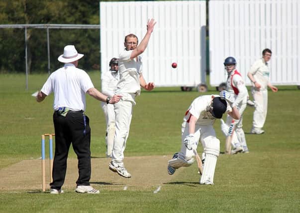 A Waringstown batsman ducks for cover as the ball is returned from the field in the match against Ballymena Seconds. INBT 21-821H