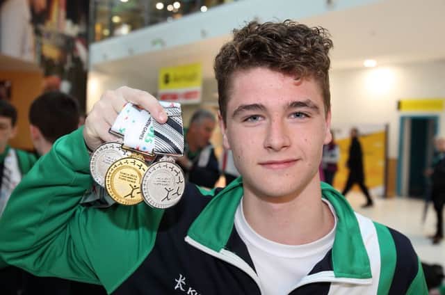 Conor Ferguson from Larne Swimming Club arriving back at George Best airport after winning a gold and two silver medals at the Commonwealth Games in Samoa. US1537-576cd  Picture: Cliff Donaldson