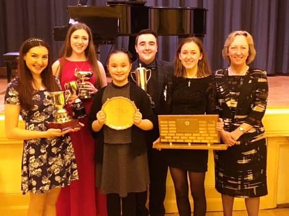 Winners at the Saturday night gala at Carrick Festival are, from left, Aimee Neill ,  Jack Dalrymple Trophy; Grainne White, James Graham Scholarship and The Rose Bowl; Niamh Lynch, most promising pianist; Daniel Kerr, songs from the shows, The McConnell Trophy and the overall award The McCullough Salver; and Holly Hewitt, CMFA Woodwind Trophy; included is Helen Deakin, Federation adjudicator from Cornwall. INCT 20-706-CON