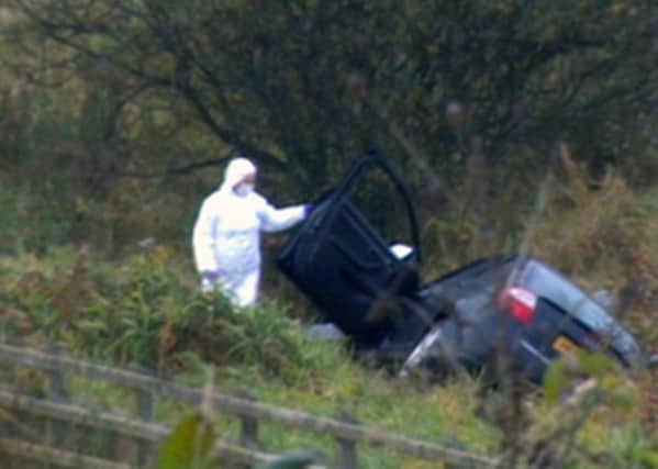 David Black's black Audi A4 car lies in a ditch off the M1 motorway  after the attack.