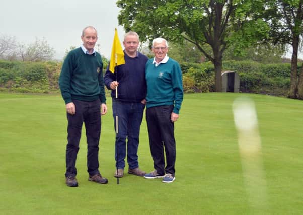 Don Carville (greens convenor), Paul Brown (head greenkeeper) and Stanley Jelly (captain) celebrate the reopening of Carrickblacker's 13th hole.INPT20-211