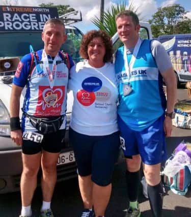 Nigel McNeill, Jackie Brogan and John Butcher at Redcastle Hotel, Donegal. Nigel and John (Tesco customers) completed a quadrathon challenge in aid of the partnership. They were supported by Jackie Brogan. inbm22-16s