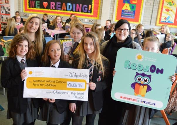 GHS literacy co-ordinator Claire Shearer and Year 8 pupils hand over the cheque to Rebecca Oates from NI Cancer Fund for Children. INNT 21-501CON