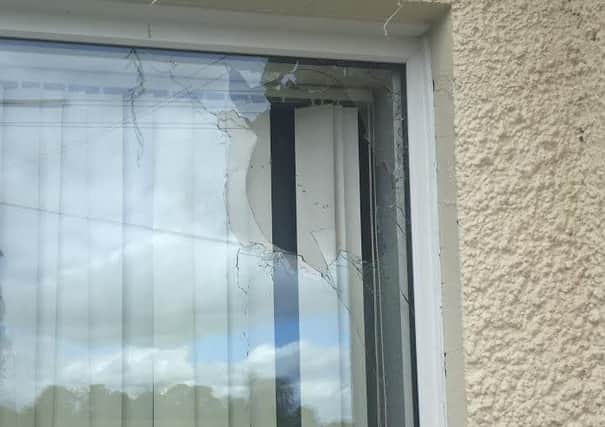 The 45-year-old resident was asleep in the living room when a shot was fired through this window. Police are treating the attack as 'attempted murder'