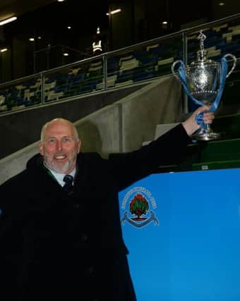 Institute chairman Bill Anderson, during happy times recently holding aloft the Intermediate Cup, feels the play-off situation needs to be sorted sooner rather than later. Picture by Gary Hancock/IFA