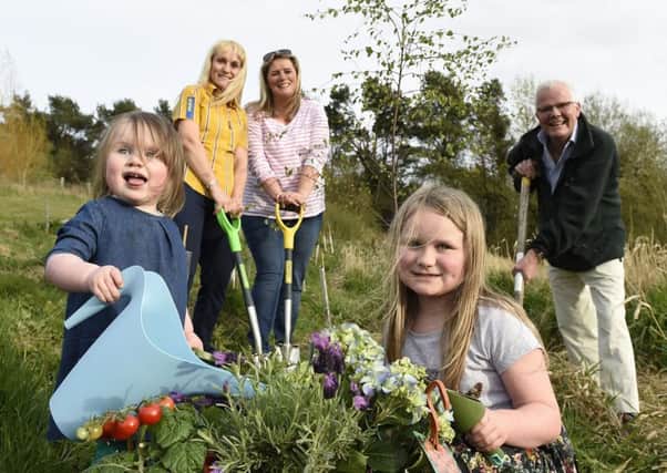 Kara and Mya Campbell, from Dromore, bring a splash of colour to a new allotment in Dromara.  Green-fingered teenagers from Dromara Community Group are creating this budding natural resource and celebrating a tree-planting milestone: a hearty one million trees now brighten neighbourhoods across the UK, thanks to IKEAs Trees for Communities initiative in partnership with the Woodland Trust. Looking on are Lynn Campbell, IKEA Belfast; Gail Burns, group leader; and Patrick Cregg, Woodland Trust.