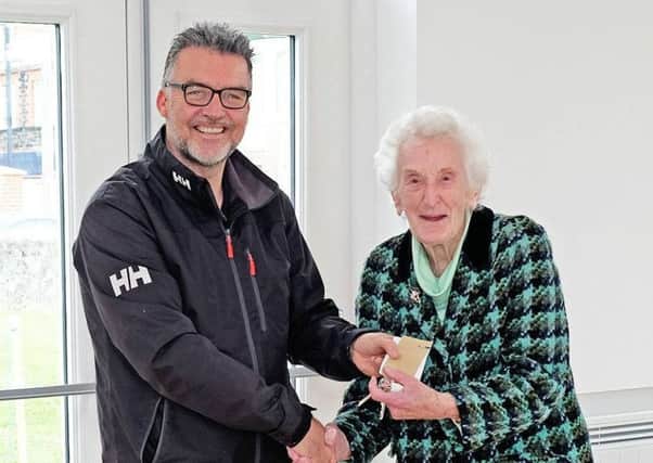 Greg Power of THP Construction hands over the keys for the new hall at Whitehead Methodist Church to Vera Girvan, one of the main benefactors of the project.  Photo by Stanley Gilpin INCT 21-736-CON
