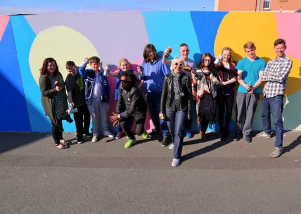 Young people who created a temporary artwork on a wall adjacent to the Verbal Arts Centre as part of a Children in Need funded Reading Rooms initiative, pictured with artist Morag Myerscough, poet Lemn Sissay and on left, Rachel Duffy, Reading Rooms Youth Project Officer.