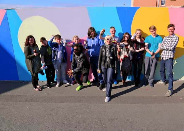 Young people who created a temporary artwork on a wall adjacent to the Verbal Arts Centre as part of a Children in Need funded Reading Rooms initiative, pictured  with artist Morag Myerscough, poet Lemn Sissay and on left, Rachel Duffy, Reading Rooms Youth Project Officer.