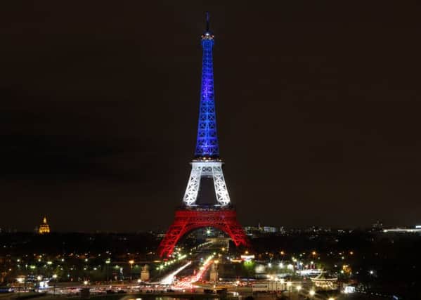 The Eiffel Tower lit in the colours of the French Nation flag after terrorist attack. PRESS ASSOCIATION Photo. Picture date: Monday November 16, 2015. See PA story POLICE Paris Eiffel. Photo credit should read: Steve Parsons/PA Wire