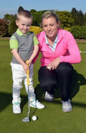 Little Sevie Trowlan (3) who is all set to make a big impact on the golf world in the future pictured at Lurgan Golf Club with his coach, Zoe Allen, PGA assistant professional at the club. INLM20-204a.