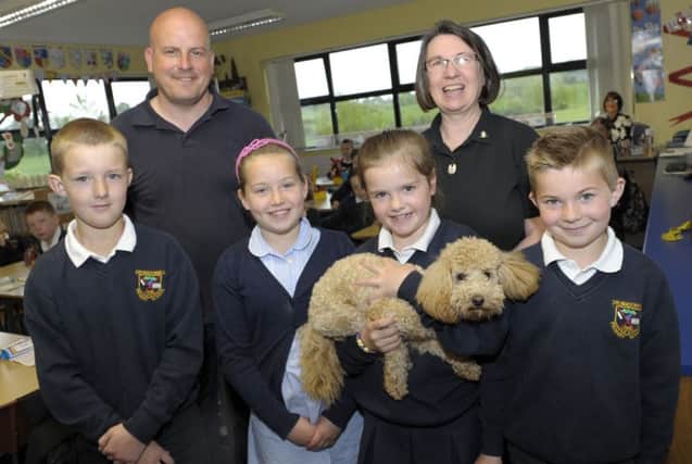 A group of  pupils from Drumadonnell Primary School, Maya, Jack, Rebeccah and Joel with "Gillie" the poodle which was a popular visitor to the school along with Cathy Clyde from Dog's Trust and Alan Priestley from Armagh City, Banbridge & Craigavon Borough Council Â©Edward Byrne Photography INBL1621-206EB