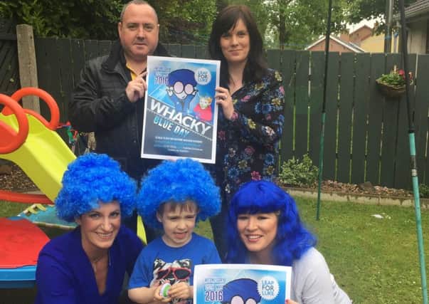 Luke O'Hanlon from Derrytresk, reminds Mid Ulster MLAs Linda Dillon and Michelle O'Neill about Whacky Blue Day which takes place this Wednesday 25 May to raise money for Duchenne Muscular Dystrophy. Log on to www.leapforluke.com to find out more about how your school or business can get involved. Also pictured is Luke's mum Claire and Cllr Joe Quinn.