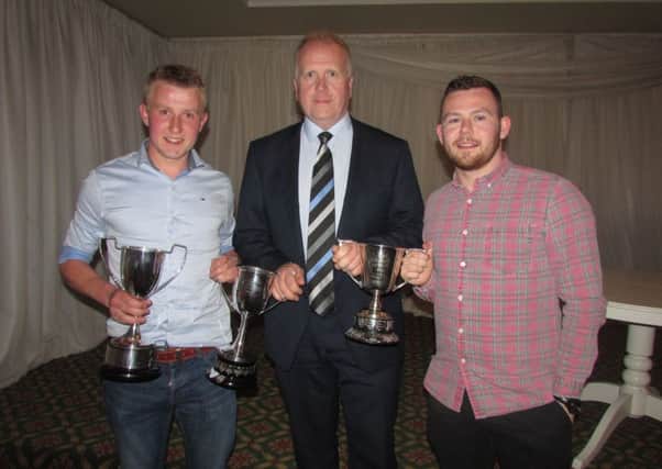 Alan Francey presents Andy Laughlin (Leading Goalscorer and Players' Player of Year) and George Young (Player of Year) with their awards at the Wakehurst Fc dinner.