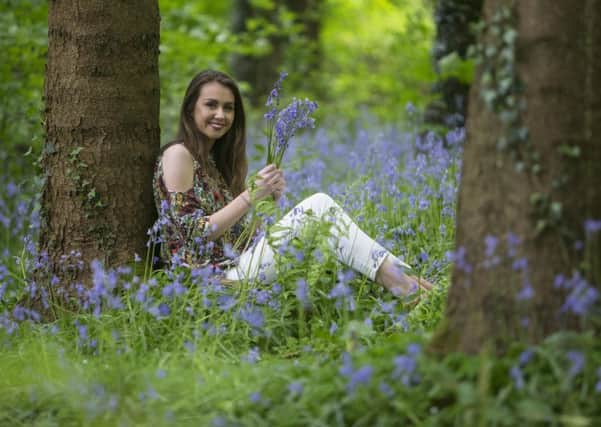 Local girl, Grace Taylor relaxes in Portglenone Forest as it turns into a bluebell bonanza, as the forest and surrounding hillsides turn into a deep blue carpet of bluebells during May.
