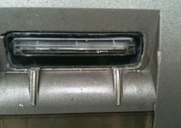 A skimming device fitted to an ATM (skimmer).
