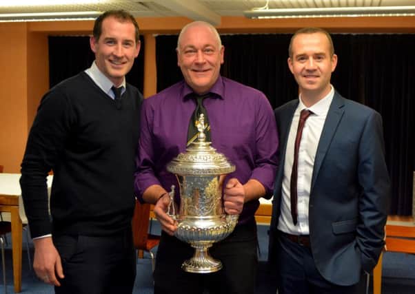 Gary Haveron, club physio Steven Luney and assistant boss Steven Mills with the Steel and Sons Cup trophy.