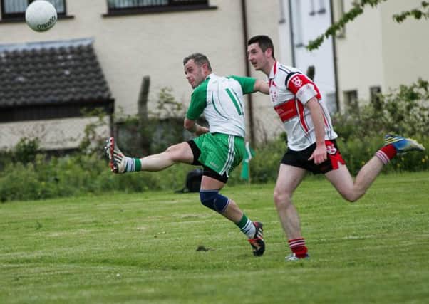 Paddy Quinn sends over a point for St Comgall's.