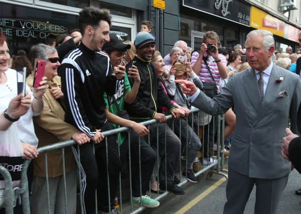 The Prince of Wales meets local people during a visit to the Yellow Door Deli at Portadown. Pic by Niall Carson/PA Wire