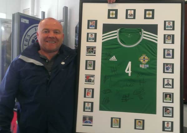 Martin Longmore with Gareth McAuley's shirt from Northern Ireland's Euro 2016 match with Greece. The shirt, signed by the whole squad, will be entered into a draw for charity. INLT-22-704-con