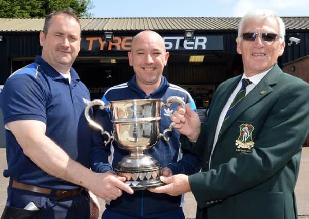 Gareth Robinson (centre) celebrates his Fullerton Cup victory at Carrickblacker with, from left, Robert Fagan (trophy sponsor, Tyremaster) and Stanley Jelly (club captain).INPT21-210