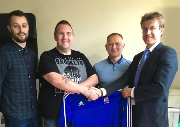 New Wakehurst manager Clifford Adams is welcomed to the club by committe member Douglas Stevenson. Also included are (left) Jason Connolly (reserve team manager) and John Clarke (assistant manager).