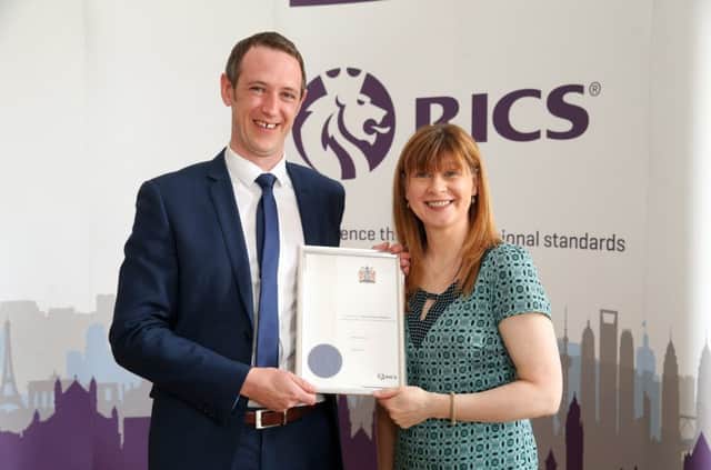 Kenneth Moore receiving his RICS diploma from Fiona Grant, RICS UK & Ireland Chair.