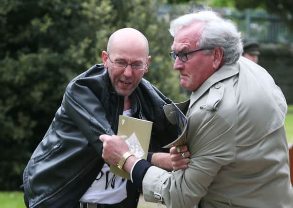 Canadian Ambassador to Ireland Kevin Vickers wrestles with a protester (left) during a State ceremony to remember the British soldiers who died during the Easter Rising at Grangegorman Military Cemetery, Dublin. PRESS ASSOCIATION Photo. Picture date: Thursday May 26, 2016. Mr Vickers helped subdue a demonstrator who began chanting "insult" at the service commemorating more than 100 British soldiers killed trying to suppress the Easter Rising a century ago. See PA story IRISH 1916. Photo credit should read: Brian Lawless/PA Wire