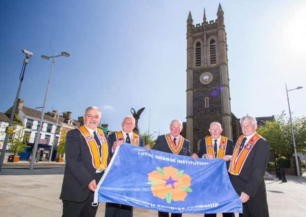 Grand Master of the Grand Orange Lodge of Ireland, Edward Stevenson (centre), presents senior Portadown Orangemen with a special flag to mark the tourist flagship status for this year's Co Armagh Twelfth of July parade. Pictured (L-R) are David Jones; Darryl Hewitt, District Master; Alan Burns and Cecil Allen