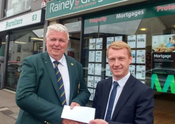 Ryan Gregg of Rainey & Gregg Property Services presents a sponsorship cheque for the Galgorm Castle Golf Club 19th Hole competition to club captain Ian Henry. INBT 21-210CS