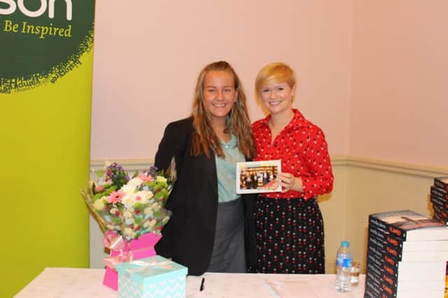 All smiles from St Patrick's Academy pupil Helen McCormick as she presents her gifts to Cecelia