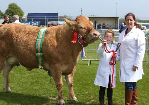 Angela Griffin from Toomebridge and her daughter Aoife with  Drumraymond Heidi Ho which won champions Blonde and Champions Cow at Ballymena Show. INBT 22-122JC