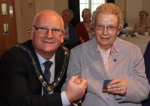 Mayor of Mid & East Antrim Cllr Billy Ashe presents a special medal to 90 year old Esther Jackson, one of nineteen of such medals which were handed out at Friday's tea dance in the Braid Arts Centre to commemorate the 90th birthday of HRH Queen Elizabeth. INBT 22-107JC