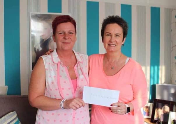 Pictured is Michelle's mum, Julie, presenting a cheque to Karen McMeekan of 1in3 Cancer Support.  INCT 22-737-CON