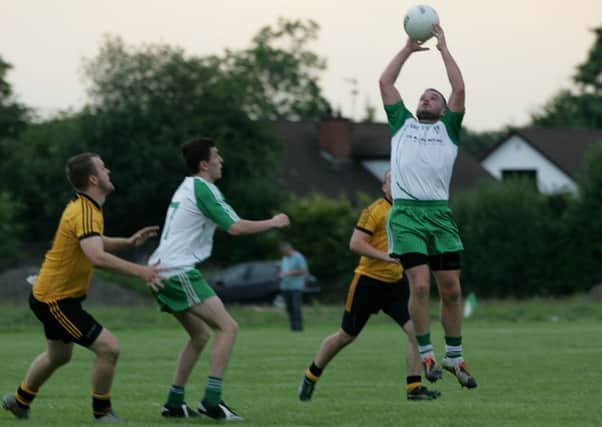 Paddy Quinn rises to secure the ball for St Comgall's.