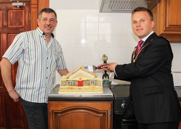 Mayor Thomas Hogg and Men's Shed Chairperson Mark McGranaghan cut the cake to mark the official opening of Newtownabbey Men's Shed at Merville House. INNT 19-517-SO