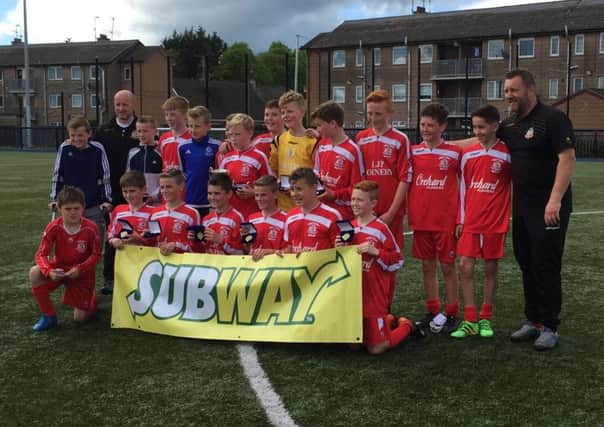 Portadown under 13s players and coaching staff celebrate victory in the NIBFA National League Section B. Victory on the final day of the season against Foyle Harps in Brownstown Park wrapped up the title.