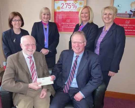 Staff from the Lisburn Branch of the Progressive Building Society along with their Manager, Mr Ian Nelson, presenting a cheque for Â£2,500 to Robert Apsley from the Lisburn Leo Talking Newspaper to fund their charity. Lisburn Leo supports blind or partially-sighted members of the community. INUS progressive