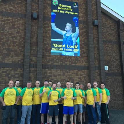 Steven Donnelly and his supporters from All Saints Boxing Club who have erected a sign in the Olympic boxer's honour at the Cushendall Road clubrooms.